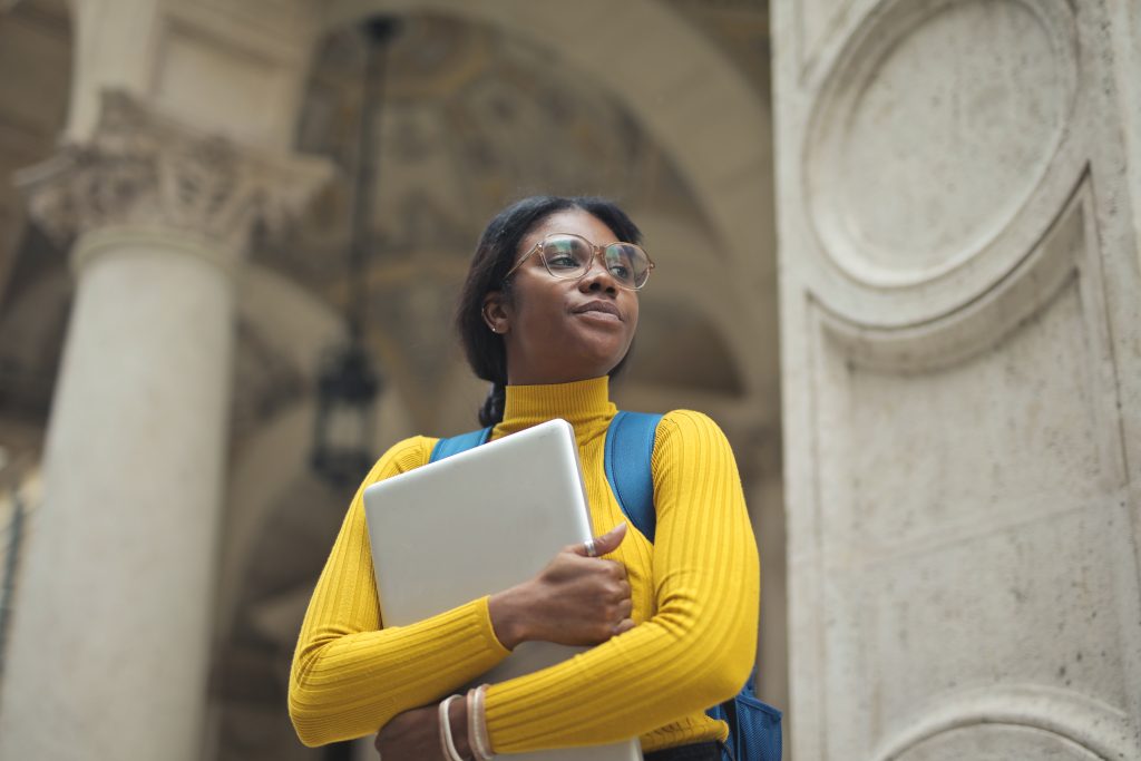 portrait of young woman with laptop in hands outside a school
7 Side hustles students can pursue in the UK